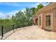 Expansive stone patio with wrought iron railing, offering scenic views of lush greenery at 2867 Darlington Run, Duluth, GA 30097