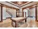 Beautiful pool room adjacent to staircase, featuring coffered ceilings and wooden pool table at 2867 Darlington Run, Duluth, GA 30097