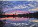 Picturesque lake scene with a vibrant sunset casting colorful reflections on the water near luxury homes at 2867 Darlington Run, Duluth, GA 30097