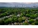 Expansive aerial view showcases the neighborhood's lush greenery with a cityscape view in the background at 1277 Avalon Ne Pl, Atlanta, GA 30306