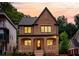 Stunning two-story brick home featuring large windows, manicured landscaping, and a classic, elegant design at 1277 Avalon Ne Pl, Atlanta, GA 30306