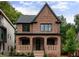 Charming two-story brick home featuring black-framed windows, and professionally landscaped front yard at 1277 Avalon Ne Pl, Atlanta, GA 30306