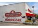 A neighborhood restaurant in Morningside features outdoor seating and signage; 'The Gathering Dog' at 1277 Avalon Ne Pl, Atlanta, GA 30306