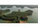 Lush, green, wooded island view from above surrounded by crystal waters providing a serene and secluded paradise at 628 Skytop Dr # 158, Cumming, GA 30040