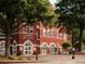 Exterior view of Cumming City Hall showcasing its classic brick architecture and landscaped surroundings at 628 Skytop Dr # 158, Cumming, GA 30040