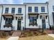 Charming two-story townhomes with brick accents and well-manicured lawns, offering a welcoming curb appeal at 628 Skytop Dr # 158, Cumming, GA 30040