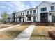 Attractive townhome exteriors with modern design, dark window frames, and well-manicured lawns at 628 Skytop Dr # 158, Cumming, GA 30040