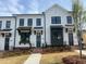 New construction townhomes boasting white exteriors, black accents, and landscaped front yards at 628 Skytop Dr # 158, Cumming, GA 30040