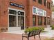 Brick building featuring Myth & Legend Coffee House, surrounded by landscaped greenery and bench seating at 628 Skytop Dr # 158, Cumming, GA 30040