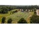 Aerial view of a football field surrounded by green trees perfect for recreational activities and community events at 628 Skytop Dr # 158, Cumming, GA 30040