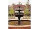 Elegant tiered fountain serving as a focal point in a charming community gathering space at 628 Skytop Dr # 158, Cumming, GA 30040