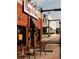 Village Burger restaurant with outdoor seating, featuring a classic brick facade and street view at 628 Skytop Dr # 158, Cumming, GA 30040