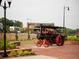 Antique steam tractor display in a brick-paved area within a beautifully landscaped city center at 628 Skytop Dr # 158, Cumming, GA 30040