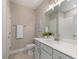 Well-lit half bathroom features a white vanity, framed mirror, and light beige walls at 248 Persimmon Dr, Holly Springs, GA 30115