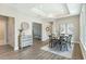 Sunlit dining room with a modern table set, tray ceiling, and decorative art at 248 Persimmon Dr, Holly Springs, GA 30115