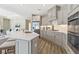 Open-concept kitchen with an island, stainless steel appliances, and gray cabinetry at 248 Persimmon Dr, Holly Springs, GA 30115