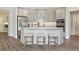 Modern kitchen featuring a large island with seating, stainless steel appliances, and stylish countertops at 248 Persimmon Dr, Holly Springs, GA 30115