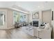 Bright and airy living room with a fireplace, tray ceiling, and large windows at 248 Persimmon Dr, Holly Springs, GA 30115
