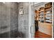 A glass-enclosed tile shower can be seen from the walk-in closet with a tile floor at 1080 Peachtree Ne St # 2512, Atlanta, GA 30309