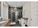 Bathroom featuring modern design elements including a glass-enclosed shower, vanity and granite countertops at 1080 Peachtree Ne St # 2512, Atlanta, GA 30309