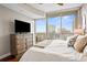 A spacious bedroom with amazing city views seen from floor to ceiling windows with an outdoor balcony at 1080 Peachtree Ne St # 2512, Atlanta, GA 30309