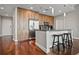 Modern kitchen with stainless steel appliances, wooden cabinets, and a breakfast bar at 1080 Peachtree Ne St # 2512, Atlanta, GA 30309