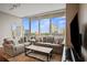 Inviting living room with comfortable seating and large windows showcasing city views at 1080 Peachtree Ne St # 2512, Atlanta, GA 30309