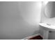 Modern bathroom featuring a pedestal sink and a round mirror, creating a clean and stylish space at 4106 Dahlgreen Way, Decatur, GA 30032