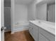 Spacious bathroom featuring a double vanity, bathtub, and glass-enclosed shower for a relaxing experience at 4106 Dahlgreen Way, Decatur, GA 30032