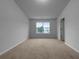 Bright bedroom with large window offering natural light and soft carpet flooring, perfect for relaxation at 4106 Dahlgreen Way, Decatur, GA 30032