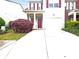 Charming two-story home featuring a well-maintained lawn and driveway leading to an attached garage at 4106 Dahlgreen Way, Decatur, GA 30032