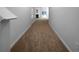 Inviting hallway featuring neutral paint and carpet leading to a cozy living space with sliding glass doors at 4106 Dahlgreen Way, Decatur, GA 30032