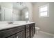 Bathroom features a double sink vanity with dark cabinetry and a window for natural light at 1068 W Union Grove Cir, Auburn, GA 30011