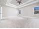 Spacious bedroom features a tray ceiling with a fan and large windows at 1068 W Union Grove Cir, Auburn, GA 30011