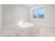 Bright bedroom with neutral paint, plush carpet, and a large window allowing ample natural light at 1068 W Union Grove Cir, Auburn, GA 30011