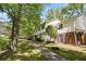 Traditional-style home featuring a brick facade and symmetrical design with mature trees in a landscaped yard at 6584 Sleepy Hollow Ln, Morrow, GA 30260