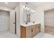 Well-lit bathroom features double sinks, white countertops, wood cabinets, and a large mirror at 111 Henley St, Canton, GA 30114