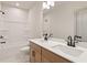 Bright bathroom with double sinks and a tub/shower combination is efficient and modern at 111 Henley St, Canton, GA 30114