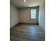 Bright bedroom featuring wood-look flooring and a window with a view at 111 Henley St, Canton, GA 30114