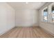 Bright bedroom with hardwood floors, a large window, and neutral wall color at 111 Henley St, Canton, GA 30114