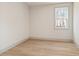 Bright, empty bedroom with a large window and neutral walls and flooring at 111 Henley St, Canton, GA 30114