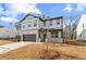 Charming two-story home with brick and siding, a well-manicured lawn, and a two-car garage at 111 Henley St, Canton, GA 30114