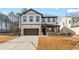 Charming two-story home with brick and siding, a well-manicured lawn, and a two-car garage at 111 Henley St, Canton, GA 30114