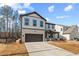 Charming two-story home with brick and siding, a well-manicured lawn, and a two-car garage at 111 Henley St, Canton, GA 30114