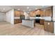 Bright kitchen features ample cabinet space, stainless steel appliances, black countertops and a central island for gathering at 111 Henley St, Canton, GA 30114