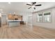 Well-lit kitchen with stainless steel appliances, wooden cabinets, an island with seating, and large windows for natural light at 111 Henley St, Canton, GA 30114