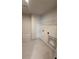 Laundry room with tile flooring and overhead shelving at 111 Henley St, Canton, GA 30114