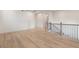 Bright living room with wood flooring boasts modern black metal railing and neutral paint at 111 Henley St, Canton, GA 30114