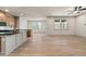 Open-concept living room with hardwood floors and kitchen featuring quartz countertop at 111 Henley St, Canton, GA 30114