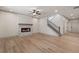 Open living room showcasing a modern fireplace, staircase, and light-colored flooring, creating a bright and inviting atmosphere at 111 Henley St, Canton, GA 30114